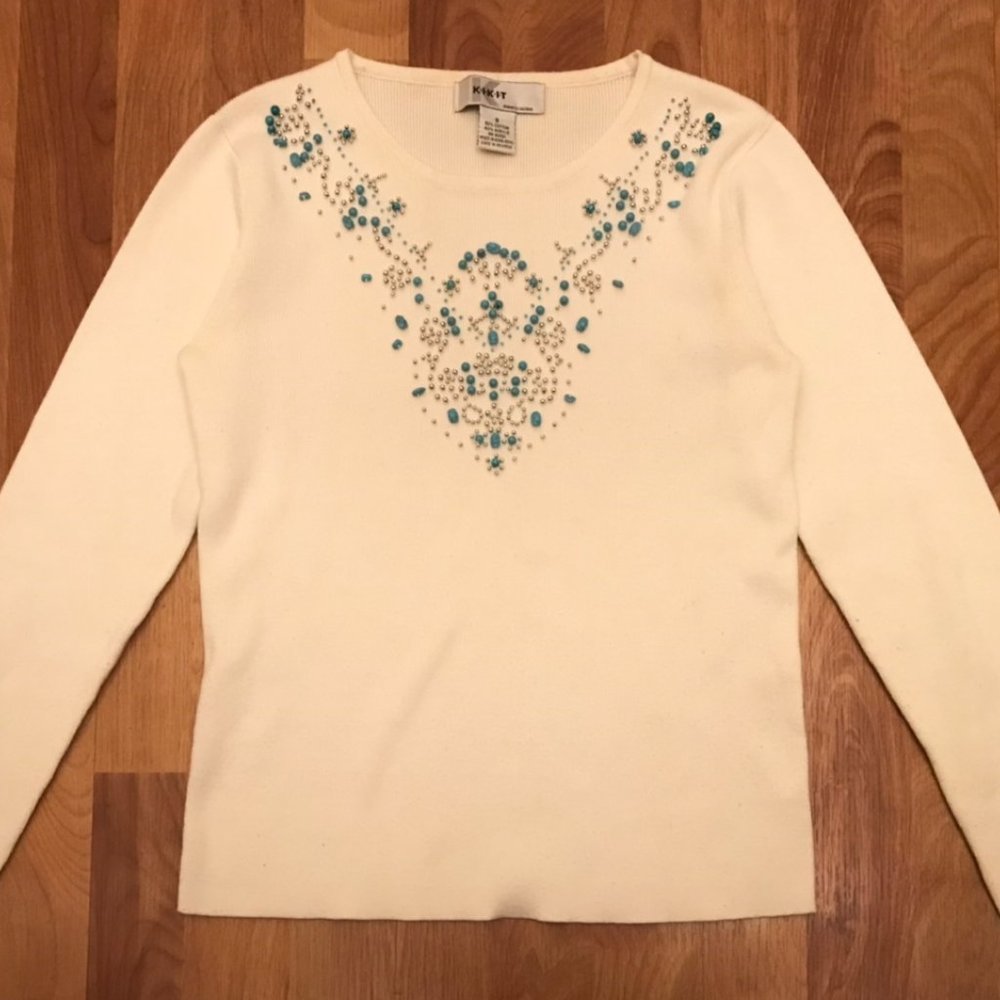 white sweater with turquoise beading